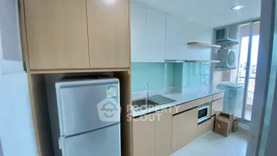 Modern kitchen with sleek cabinetry and built-in appliances in a high-rise apartment.