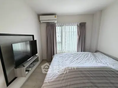 Modern bedroom with sleek design, featuring a wall-mounted TV and air conditioning, perfect for comfort and relaxation.