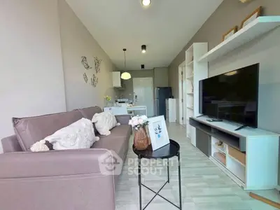Modern living room with stylish decor and open layout, featuring a cozy sofa and sleek entertainment unit.