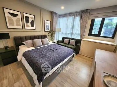 Modern bedroom with stylish decor, large bed, and natural light from corner windows.
