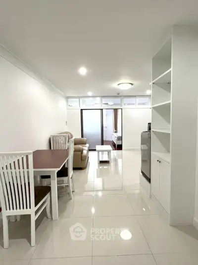 Spacious open-plan living room with dining area and modern furnishings