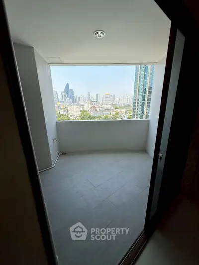 Spacious balcony with stunning city skyline view, perfect for relaxation and entertainment.