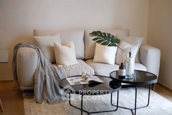 Cozy living room with stylish sofa and modern coffee tables.