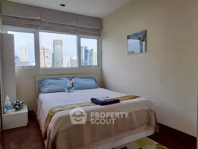 Cozy bedroom with city view, featuring a comfortable bed and modern decor, perfect for urban living.