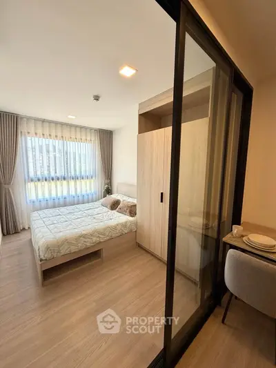 Modern bedroom with sliding glass door and natural light in stylish apartment