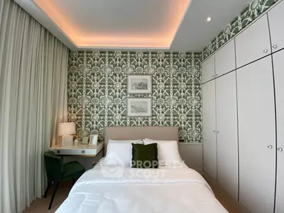 Luxurious bedroom with elegant wallpaper and cozy lighting, featuring a stylish desk and ample storage space.