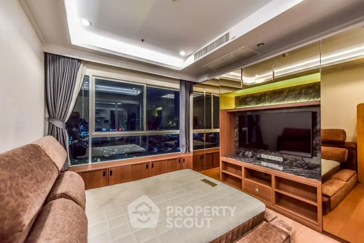 Luxurious bedroom with city view, featuring elegant furnishings and ambient lighting.
