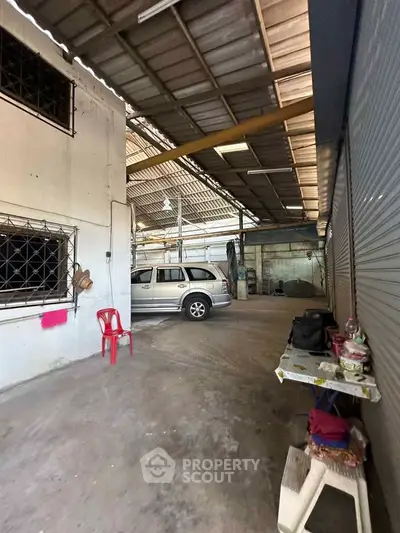 Spacious industrial garage with vehicle and storage potential