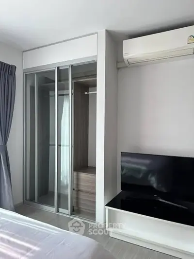 Modern bedroom with sleek closet and air conditioning unit