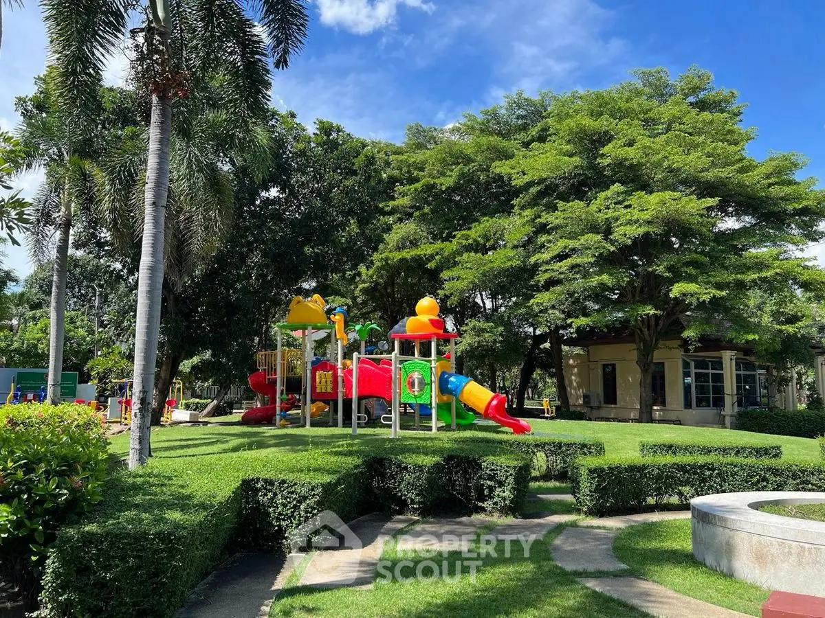Vibrant playground in lush green park setting, perfect for family-friendly real estate development.