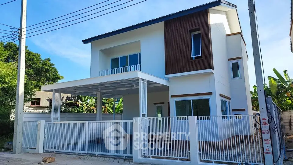 Modern two-story house with sleek design and spacious balcony in a serene neighborhood.