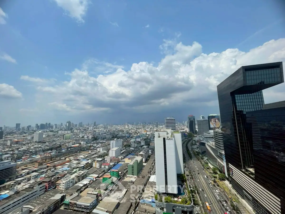 Stunning cityscape view from a high-rise building showcasing urban skyline and bustling streets.