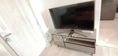 Modern living room with sleek TV stand and flat-screen television