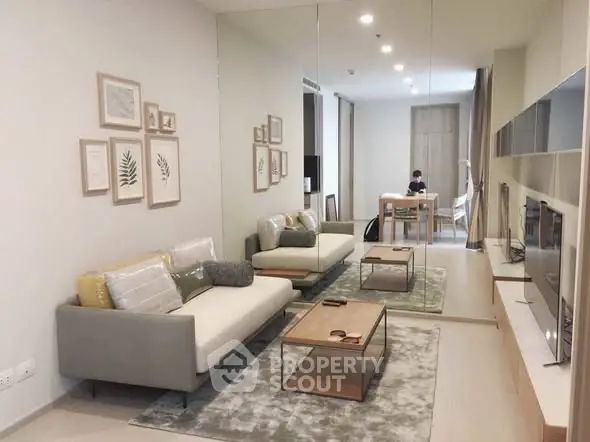 Modern living room with stylish decor and large mirror wall