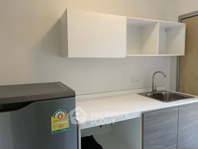 Modern kitchen with sleek cabinets and stainless steel fridge