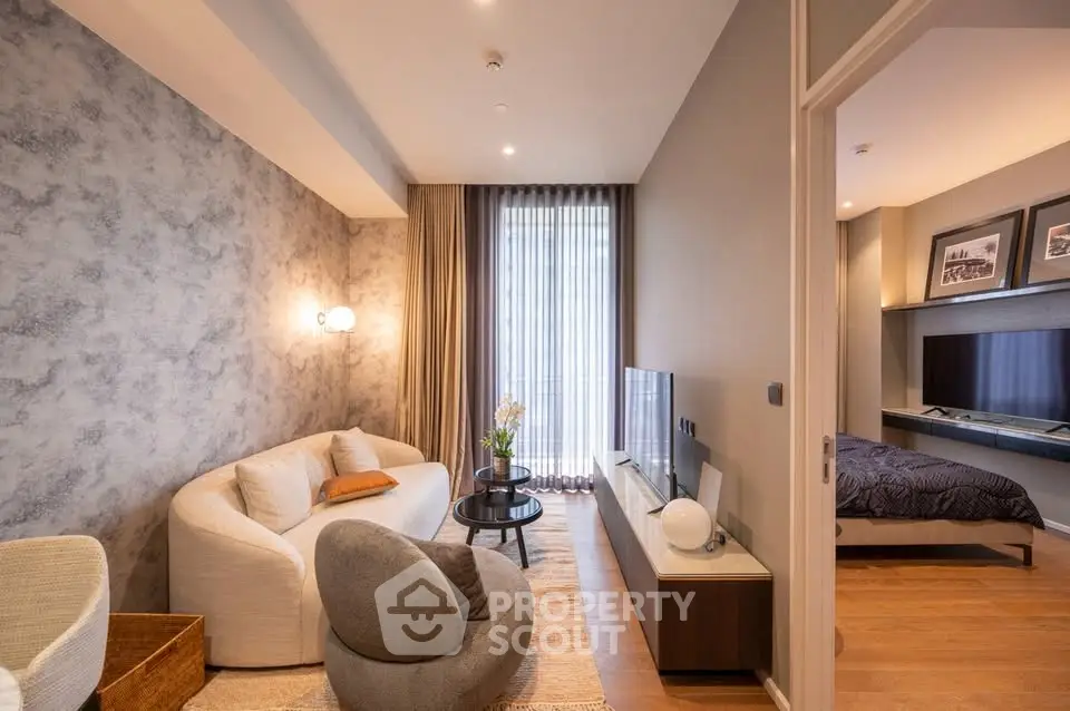 Modern living room with stylish furniture and cozy bedroom view