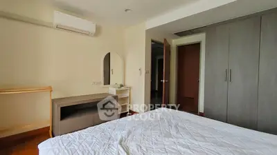 Spacious bedroom with modern furniture and ample storage space