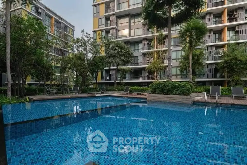 Luxurious condominium with a stunning outdoor pool and lush greenery, perfect for relaxation and leisure.