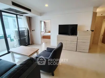 Modern living room with sleek furniture and balcony access in urban apartment