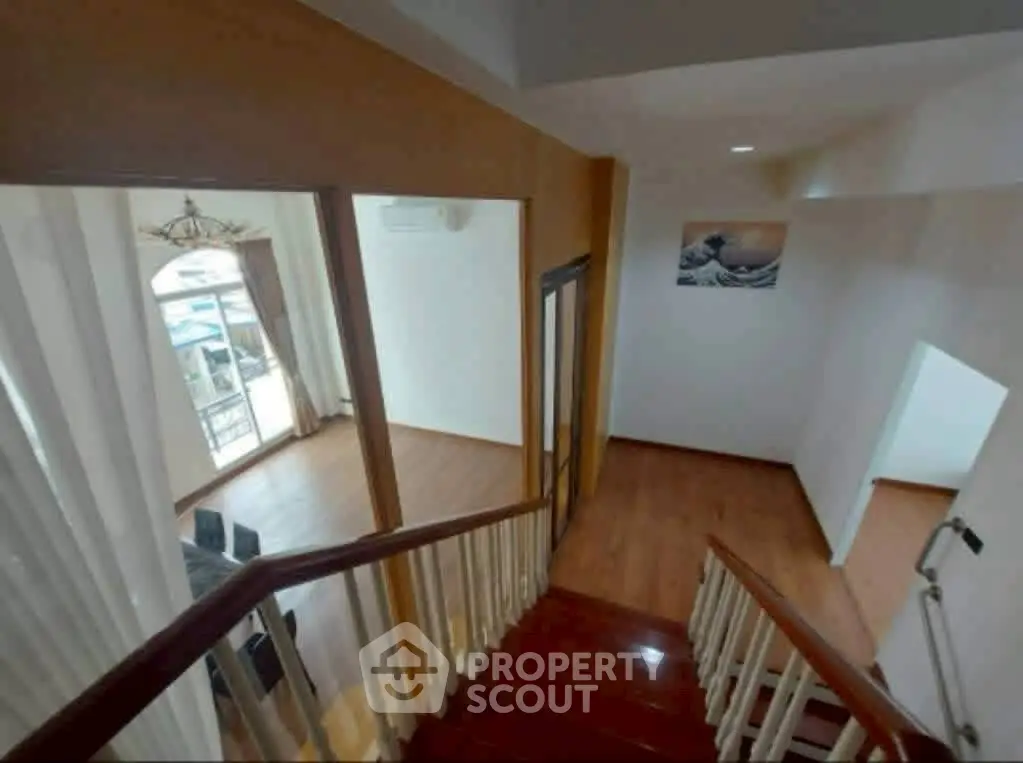 Spacious interior with wooden staircase and bright natural light