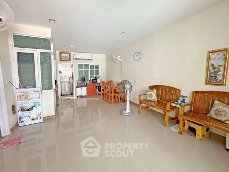 Spacious living room with open kitchen layout and wooden furniture