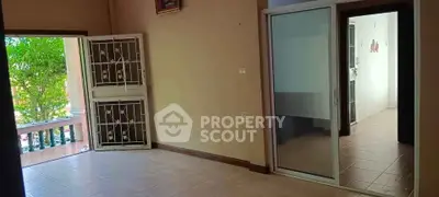 Spacious interior with sliding glass doors and balcony view, perfect for modern living.
