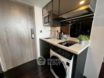 Modern compact kitchen with built-in appliances and sleek design