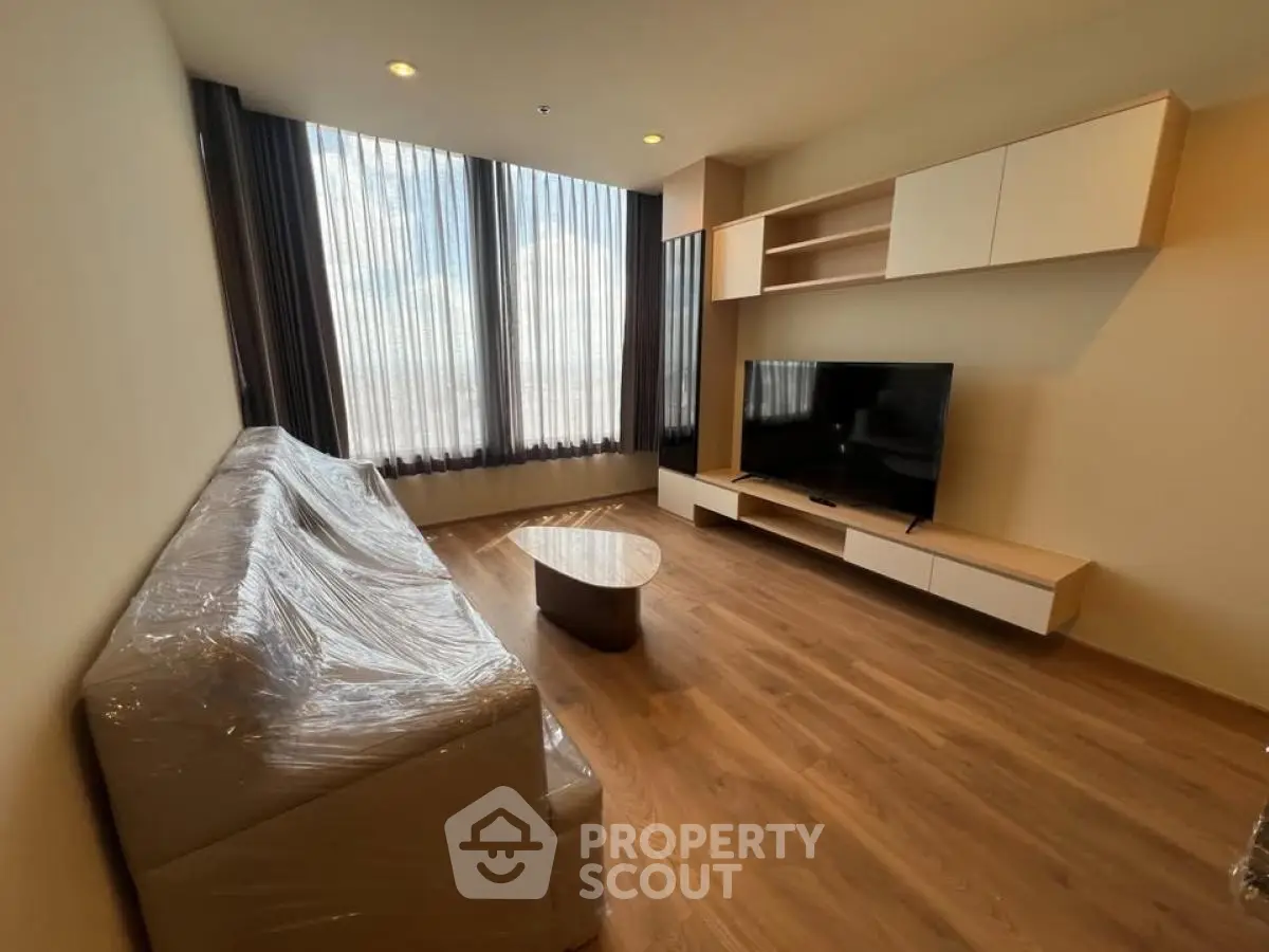 Modern living room with sleek furniture and large windows