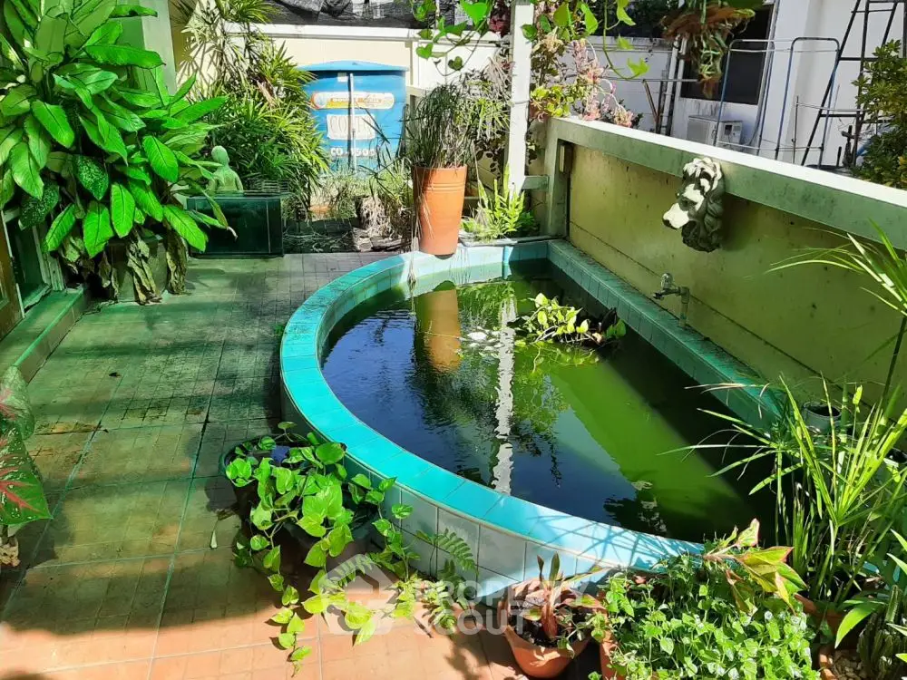 Charming garden with a serene pond and lush greenery, perfect for relaxation and outdoor enjoyment.