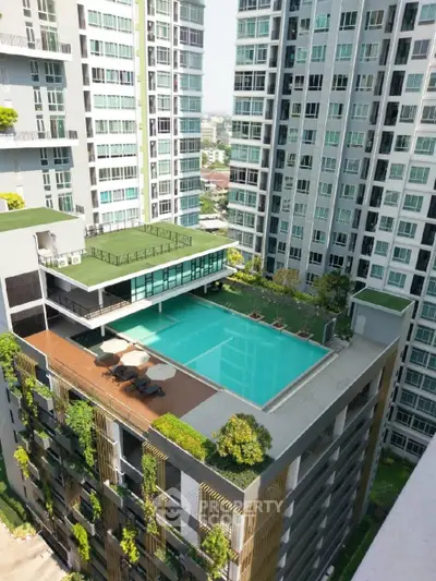 Luxurious high-rise apartment complex with stunning rooftop pool and lush greenery, offering urban living at its finest.