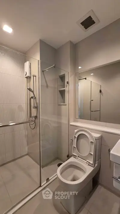 Modern bathroom with glass shower and sleek fixtures