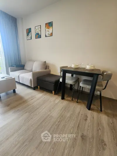 Modern living room with cozy sofa, dining table, and stylish decor in a bright apartment.