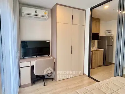 Modern bedroom with study area and kitchenette in stylish apartment