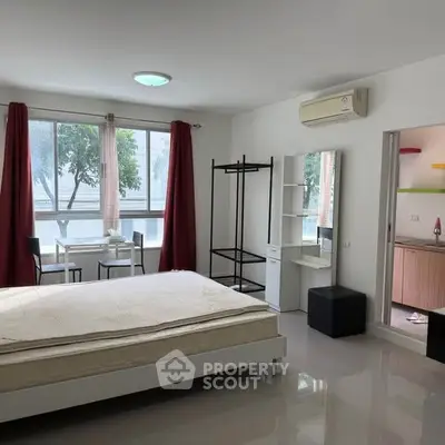 Spacious modern bedroom with large windows and minimalist decor