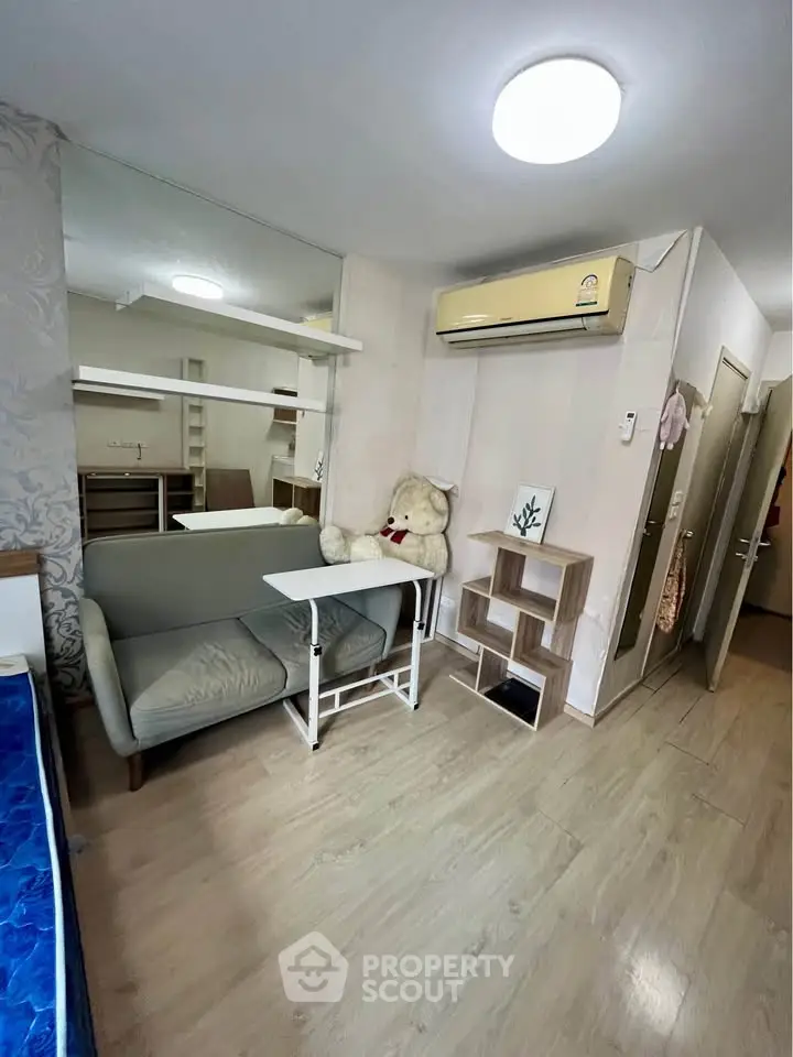 Cozy living room with modern decor and air conditioning in a stylish apartment.