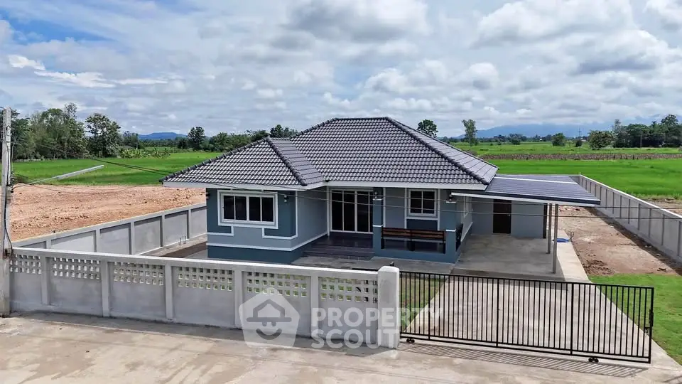 Charming single-story house with tiled roof and spacious driveway in serene countryside setting.