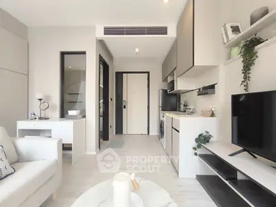 Modern open-plan living room with sleek kitchen and stylish decor