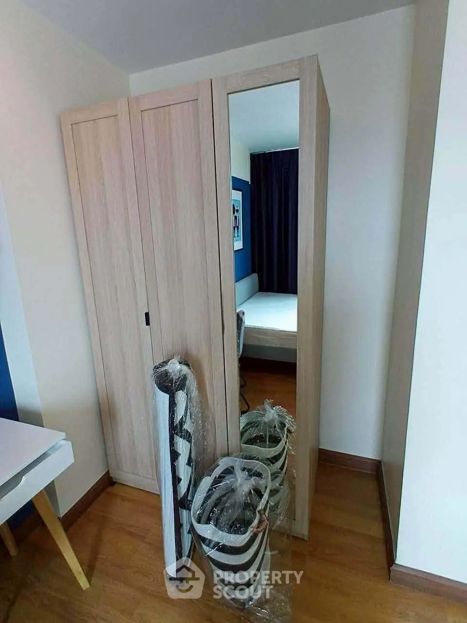 Cozy bedroom with wooden wardrobe and modern decor in a stylish apartment.