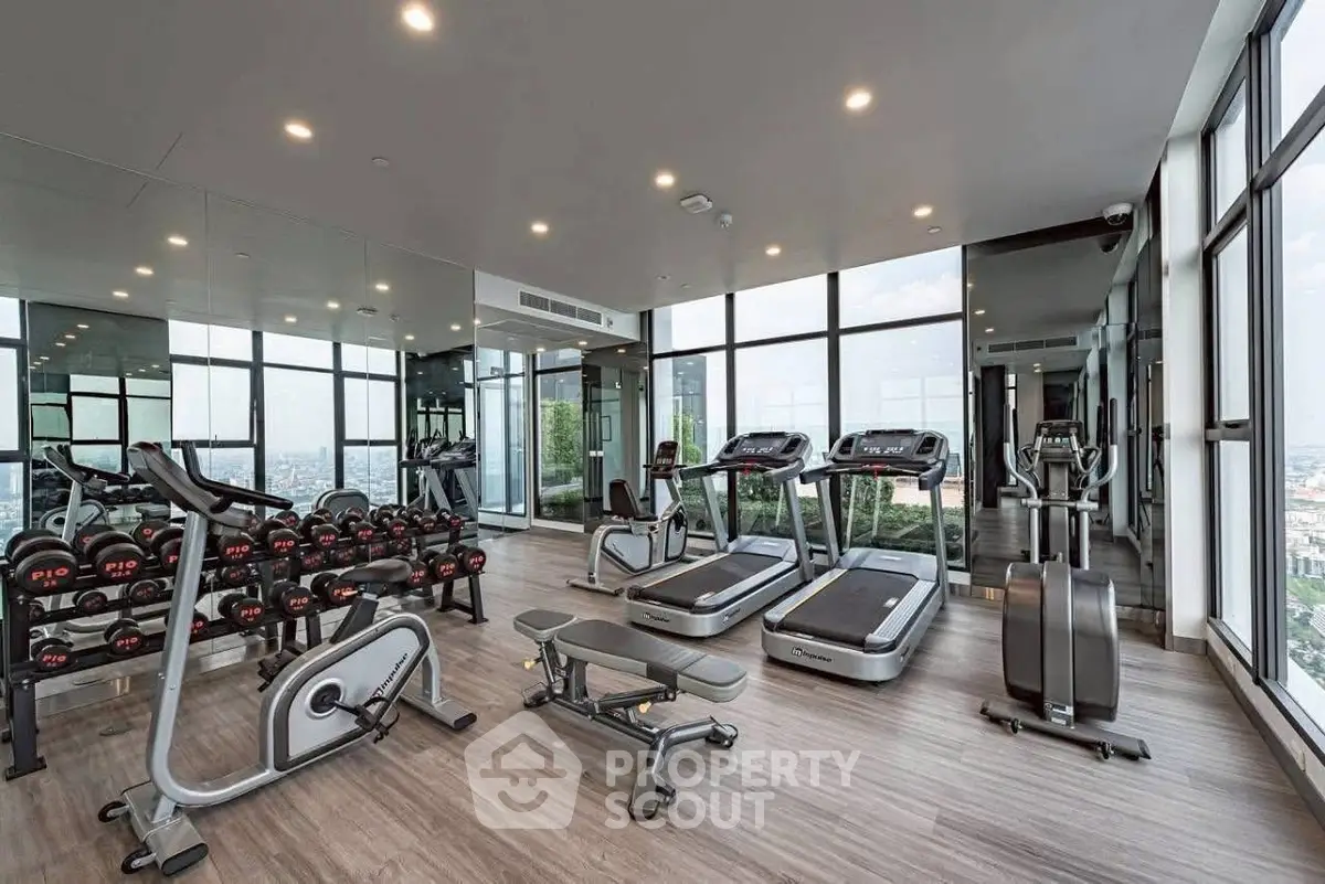 Luxurious high-rise gym with panoramic city views and modern fitness equipment.