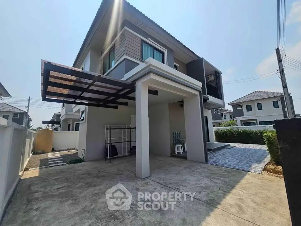 Modern two-story house with spacious driveway and contemporary design.