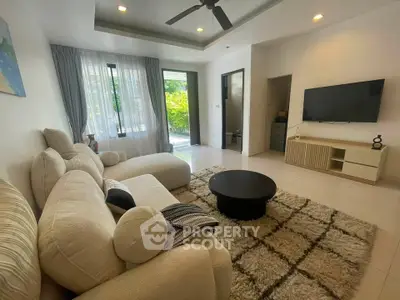 Spacious living room with modern decor and large windows for natural light.