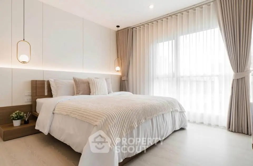Elegant bedroom with modern decor and large window for natural light
