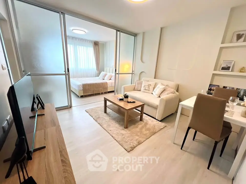 Modern open-plan living room with cozy seating and elegant decor in a stylish apartment.