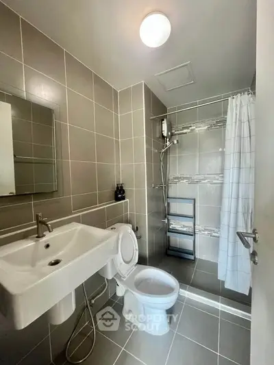 Modern bathroom with sleek tiles and walk-in shower