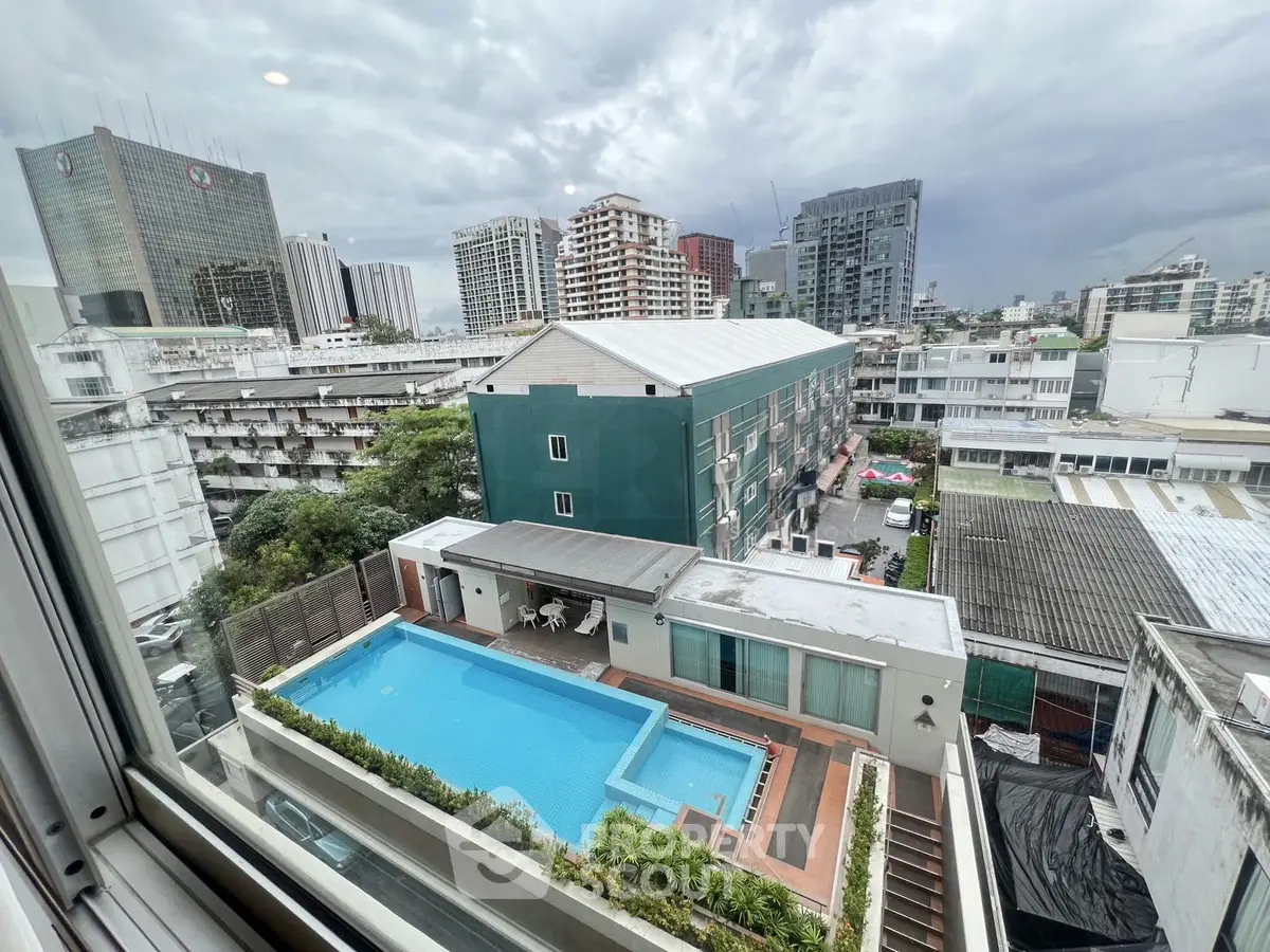 Stunning cityscape view with rooftop pool in urban residential area.