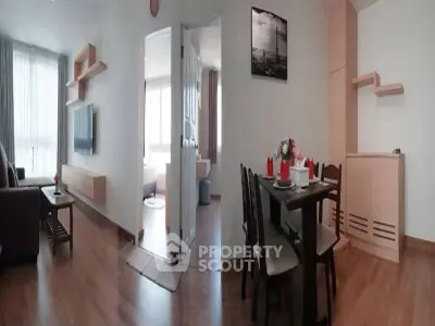 Spacious modern living and dining area with wooden flooring and stylish decor.
