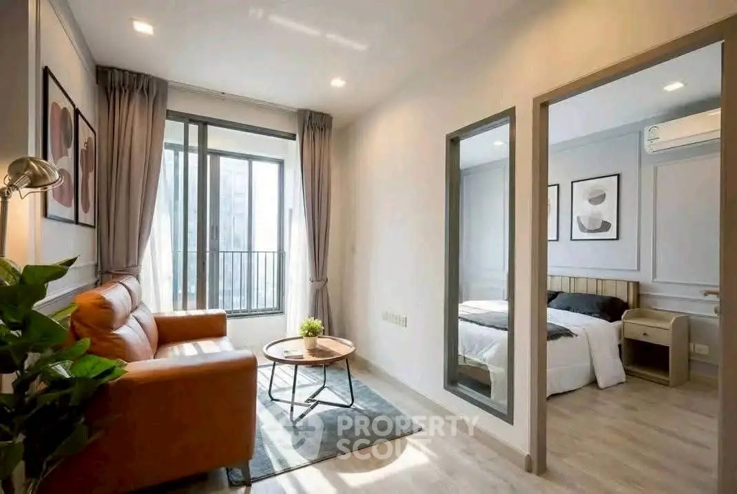 Modern apartment with cozy living room and stylish bedroom, featuring large windows and elegant decor.