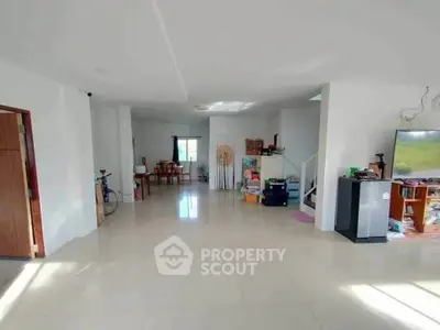Spacious open-plan living area with modern furnishings and ample natural light.