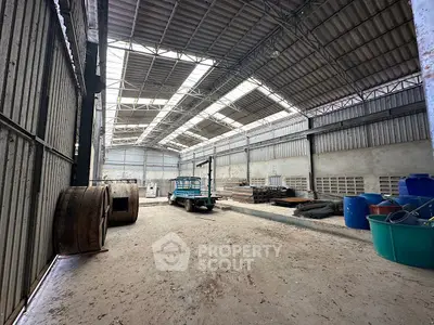 Spacious industrial warehouse with high ceilings and ample storage space.