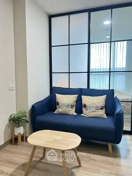 Stylish modern living room with blue sofa and wooden coffee table